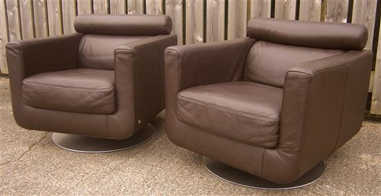 A pair of Natuzzi leather swivel armchairs W.77cm